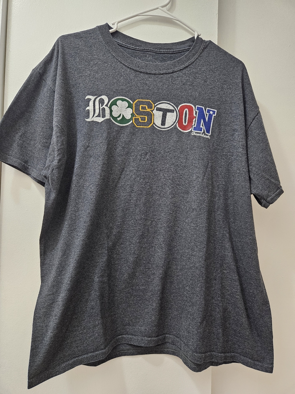 Grey 'BOSTON' graphic featuring a shamrock and team logos #boston #shamrock